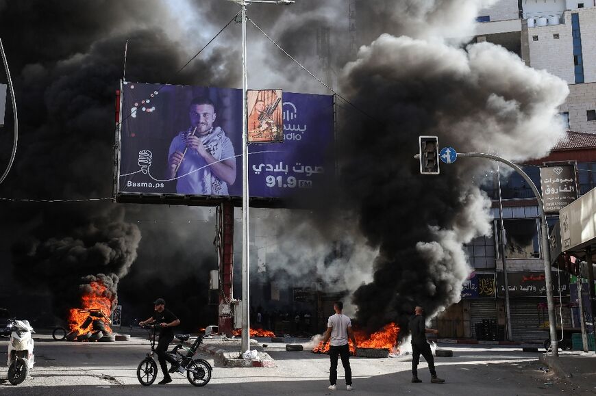 Palestinian youths burn tyres during confrontations with Israeli forces in the occupied West Bank city of Jenin