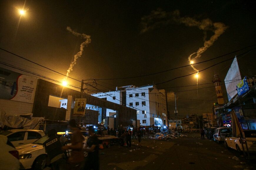 Flares dropped by the Israeli army light up the sky above Gaza City