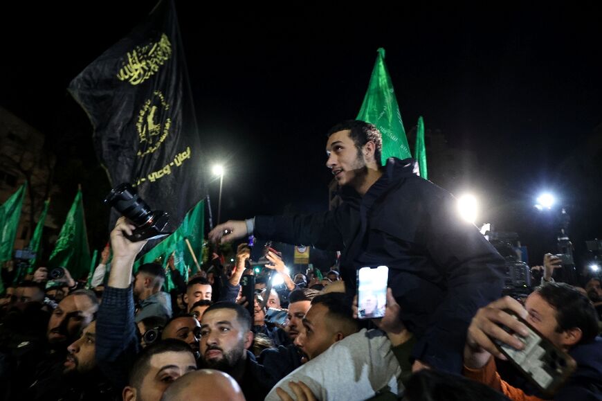 Newly released prisoners are surrounded by supporters following their release in Ramallah in the occupied West Bank on November 30