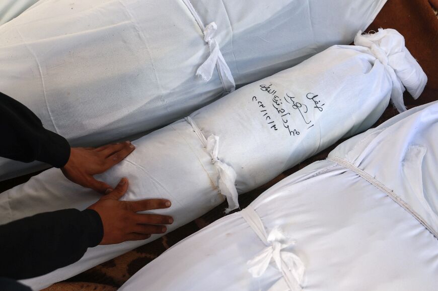 A Palestinian man mourns at al-Najjar hospital over bodies of relatives killed in Israeli bombing on Rafah, in the southern Gaza Strip