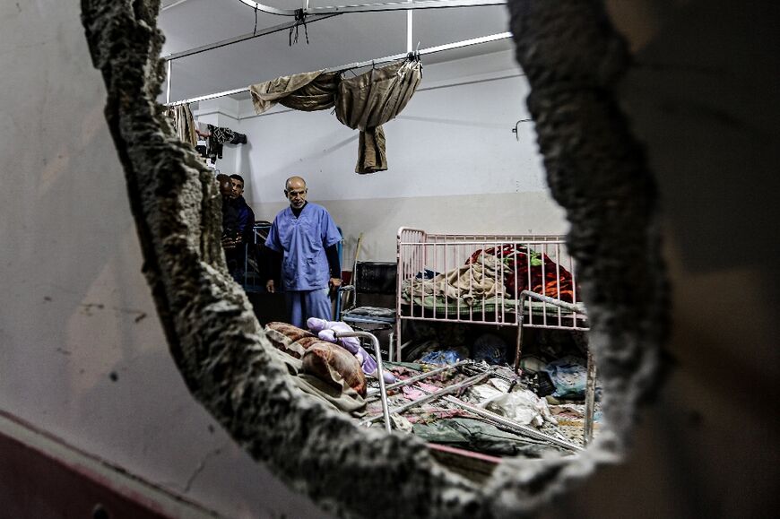 People inspect bombing damage at Nasser hospital in Khan Yunis in the southern Gaza Strip on December 17, 2023