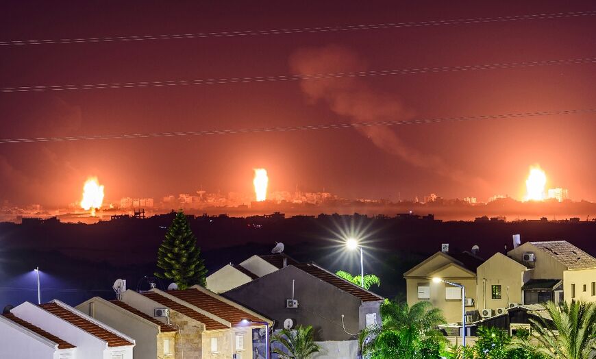 This long exposure picture taken from southern Israel near the border with the Gaza Strip shows explosions in the Palestinian territory during Israeli strikes