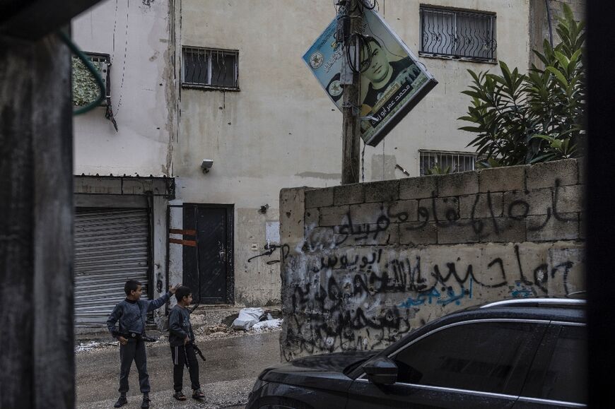 Children play with toy guns in the Jenin refugee camp