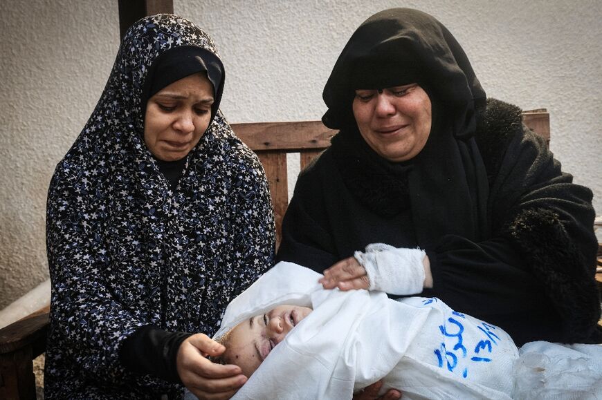 Relatives at Najjar hospital in Rafah mourn Muhannad Ashour, the youngest of victims from the same family killed in Israeli bombardment 