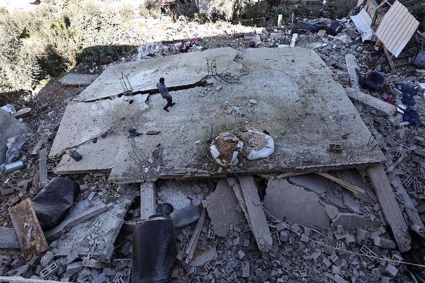 A man walks amid the rubble of a building destroyed during an Israeli army raid in the Jenin refugee camp