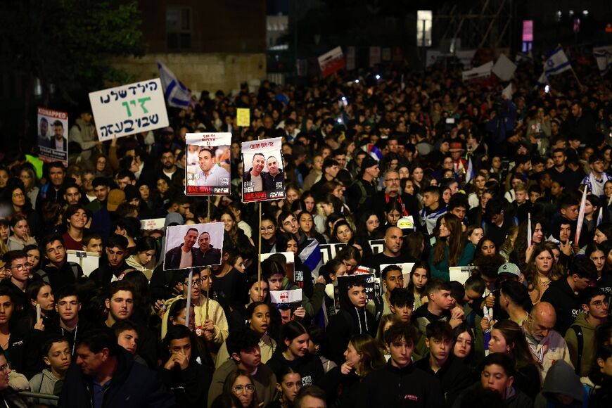 Israelis raise pictures and placards as they march to call for the release of hostages abducted by Palestinian militants during the October 7 attack, in Jerusalem on December 28, 2023