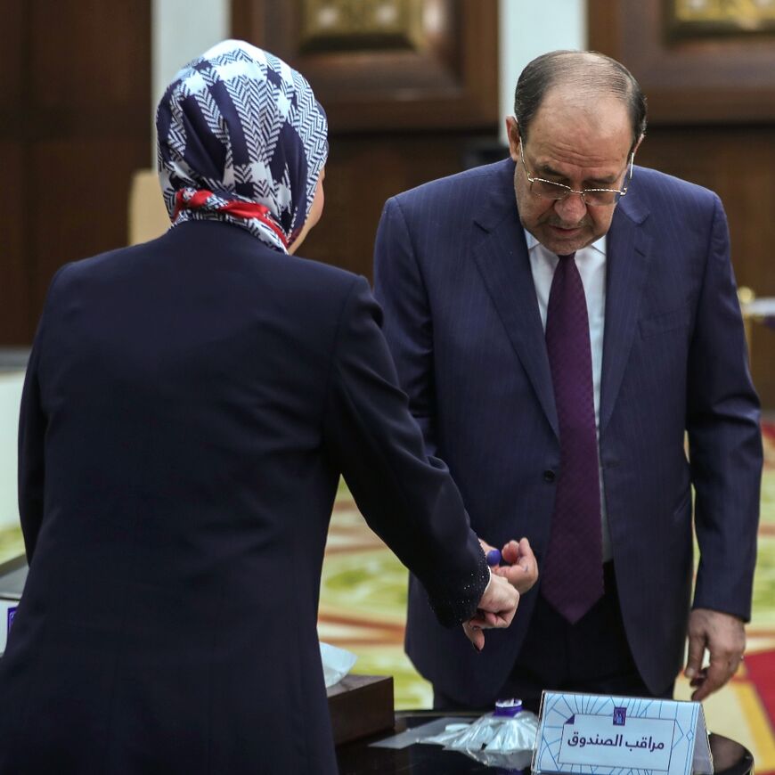 Former Iraqi prime minister Nuri al-Maliki casts his vote at a polling station in Baghdad