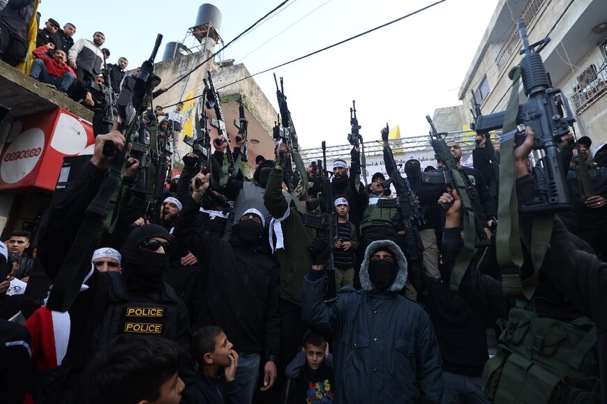 Palestinian gunmen from the Al-Aqsa Martyrs Brigades rally in the Balata refugee camp in the occupied West Bank, on December 29, 2023, to commemorate Palestinians killed in clashes with Israeli forces