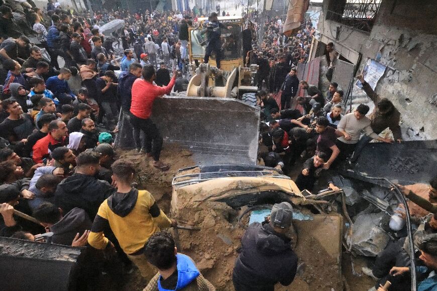 People search through the rubble after an Israeli strike on the Ali ben Abi Taleb Mosque in Rafah