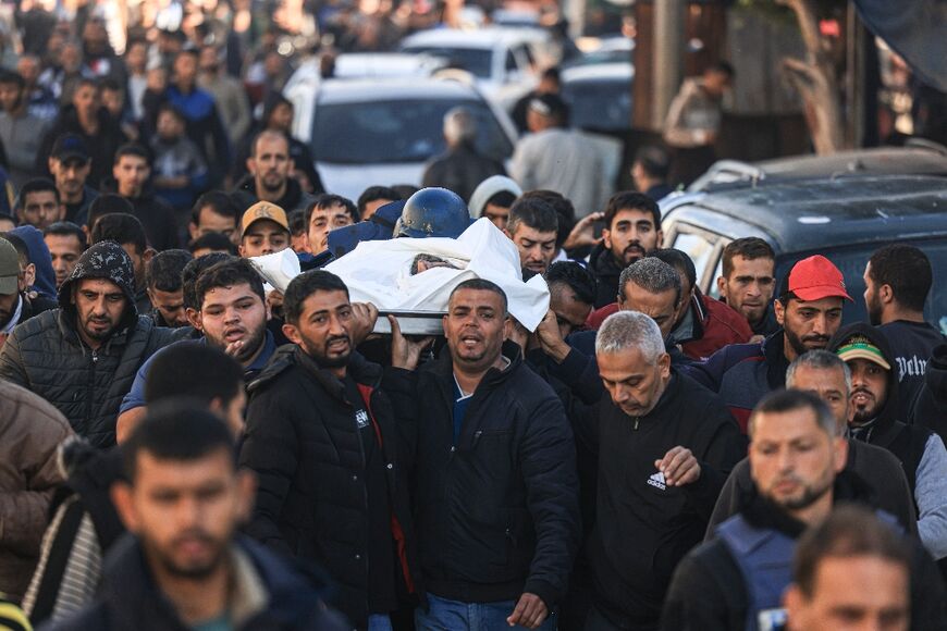 Mourners carry the body of Al Jazeera cameraman Samer Abu Daqqa, who was killed during Israeli bombardment in Khan Yunis