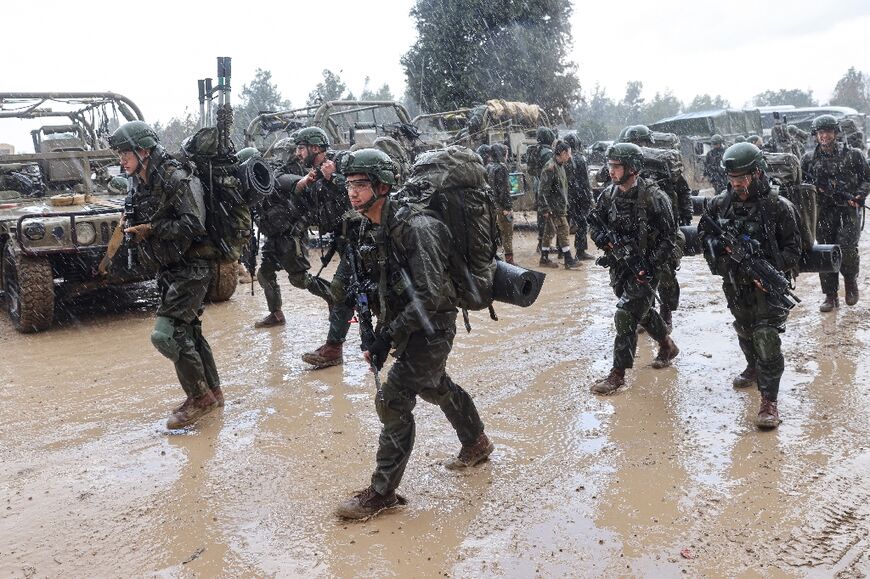 Israeli soldiers prepare to go to the Gaza Strip, near the border area in southern Israel on December 13, 2023 amid ongoing battles with the Palestinian Hamas movement