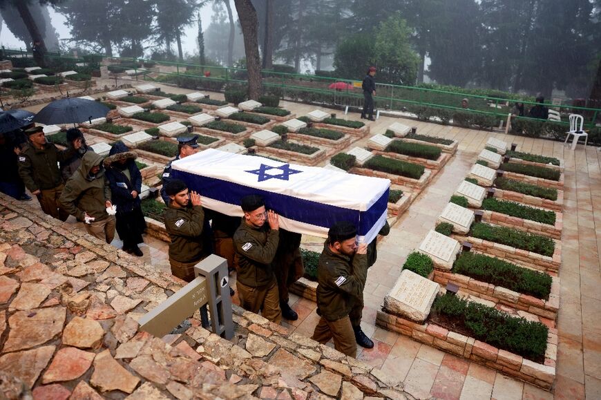 Israeli troops carry the coffin of a fellow soldier killed fighting in the Gaza Strip