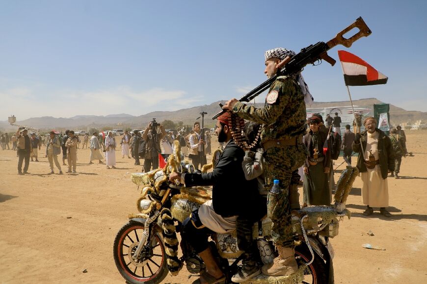 Armed supporters of Yemen's Huthi rebels attend a rally in solidarity with the Palestinian Hamas movement in Yemen's capital Sanaa