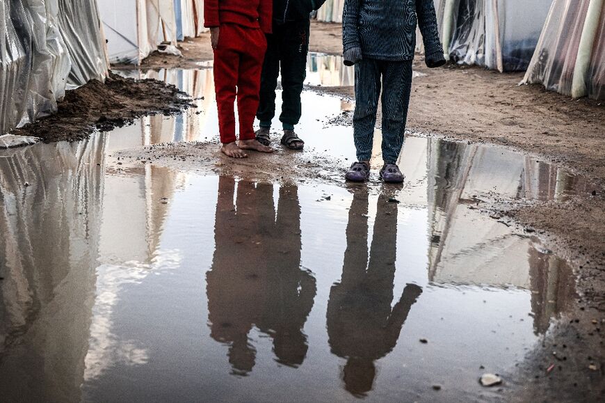 Displaced Palestinians endured a night of incessant rain and extremely cold weather