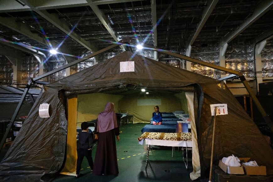 A Palestinian child sits under a tent aboard France's Dixmude military ship, at the Egyptian port of El-Arish -- the vessel serves as a hospital to treat wounded Palestinians 