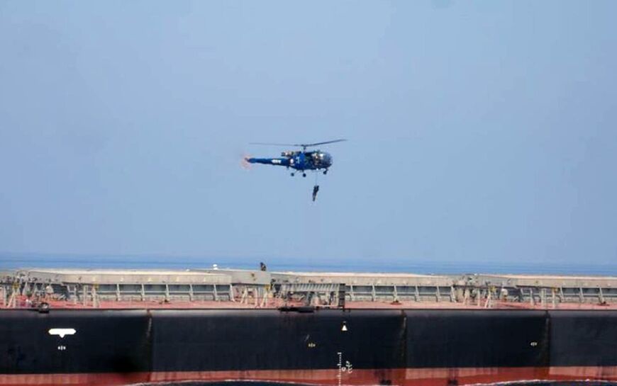 Indian commandos in the Gulf of Aden rappel from a helicopter onto a merchant vessel after an attempted pirate attack in 2008