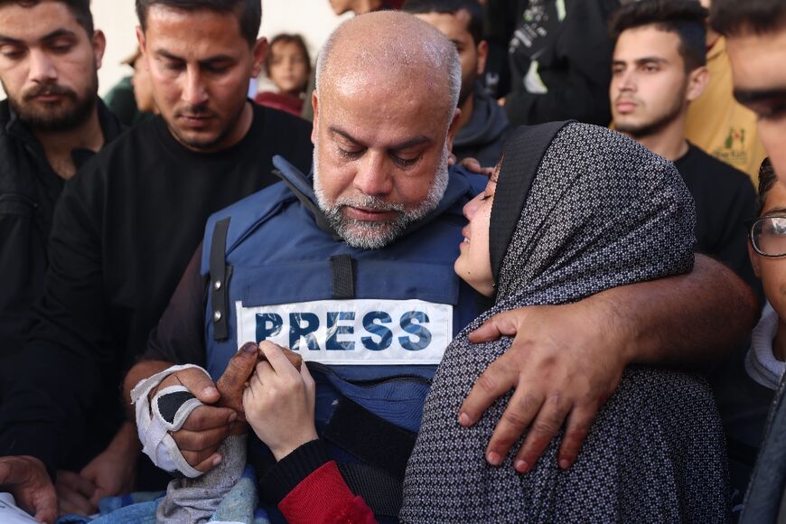 Al Jazeera's bureau chief in Gaza, Wael al-Dahdouh hugs his daughter during the funeral of his son Hamza Wael Dahdouh, a journalist, who was one of two reporters killed in an air strike in Rafah blamed on Israel 