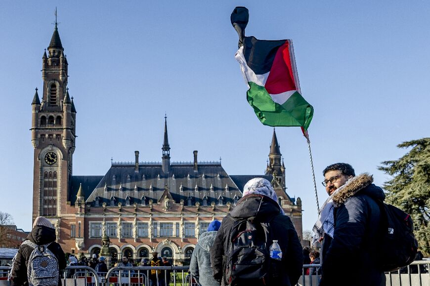 A demonstrator waves the Palestinian flag in front of the Peace Palace ahead of the ICJ verdict