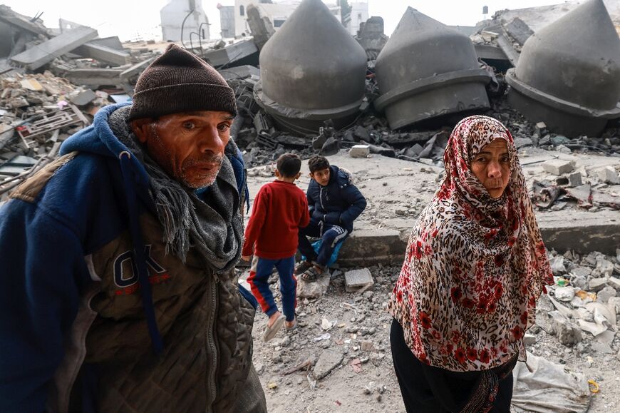 People walk past the Al-Faruq mosque, levelled by Israeli bombardment in Rafah in the southern Gaza Strip