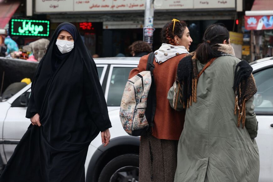 Women walk along a street in Tehran, ahead of the upcoming elections, on February 28, 2024