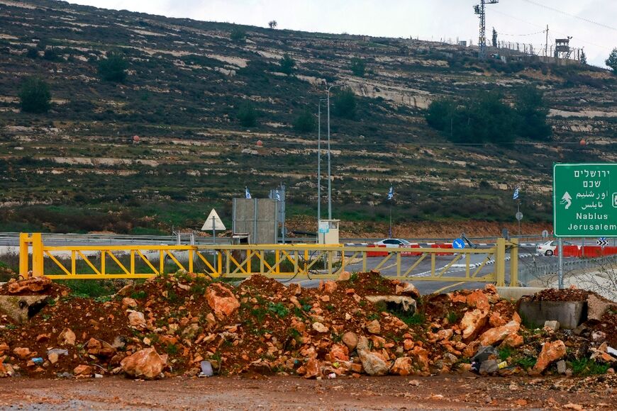 A metal barrier, piles of rocks and earth block the road between Ramallah and the West Bank city to Nablus