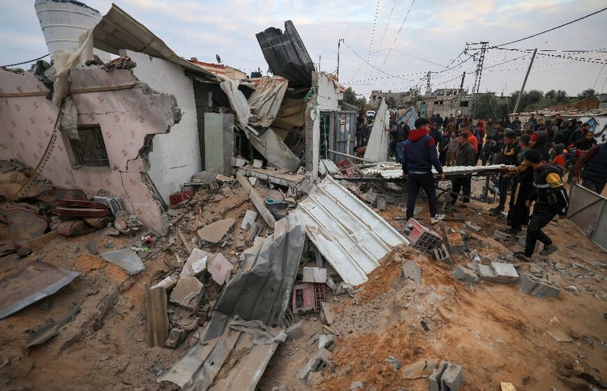 People gather around the Abu Saleh family home in Rafah in the southern Gaza Strip on February 5, 2024, after it was hit during Israeli bombardment