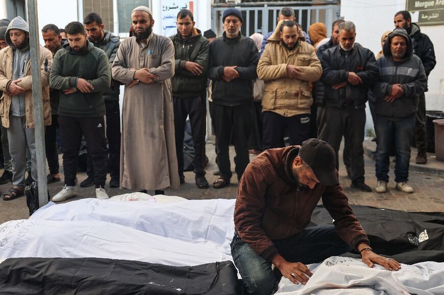 Palestinians mourn dead relatives at Rafah's Al-Najjar hospital on February 21, 2024, following overnight Israeli air strikes 