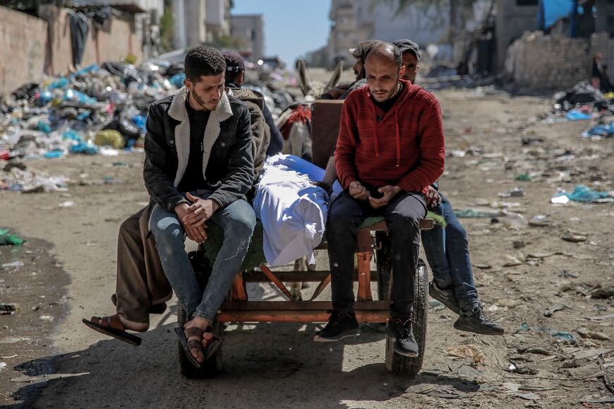 The body of a Palestinian killed in the aid truck incident is taken away in Gaza City