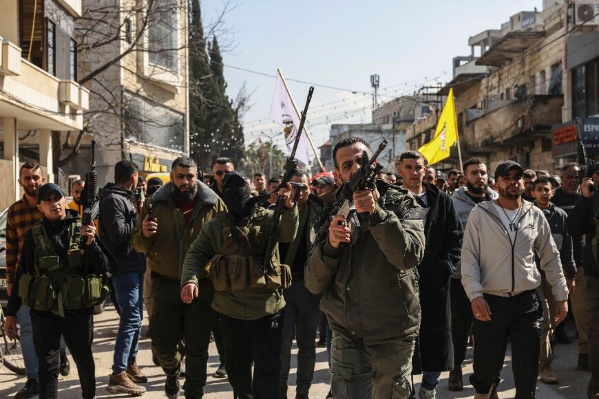 Palestinian gunmen lead the funeral procession for Aref Marwan, a fellow militant killed in clashes with the Israeli army during the overnight raid on Jenin