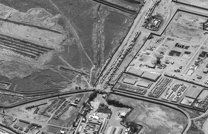 This satellite image released by Maxar Technologies shows aid trucks queuing at the Rafah crossing between Egypt and Gaza, which in theory bypasses Israel but where in practice Israel retains control