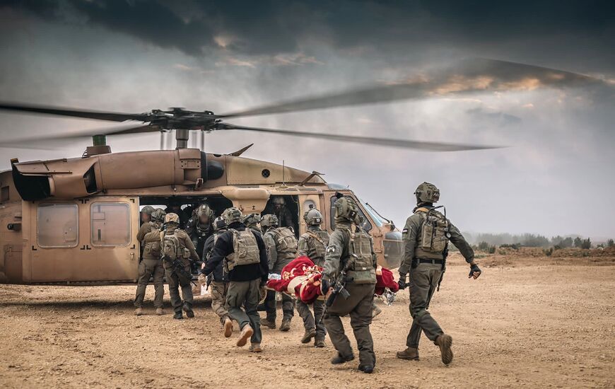 Israeli troops evacuate a wounded soldier during operations in the Gaza Strip