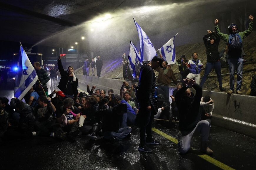 Police used water canons to disperse the crowd as they blocked a highway in Tel Aviv