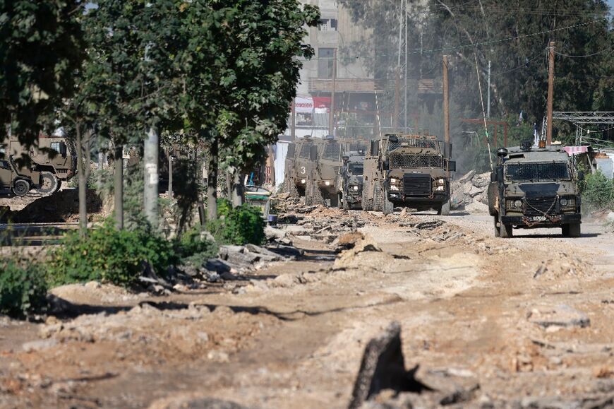 An Israeli military convoy leaves the Nur Shams refugee camp near Tulkarm, in the northern West Bank