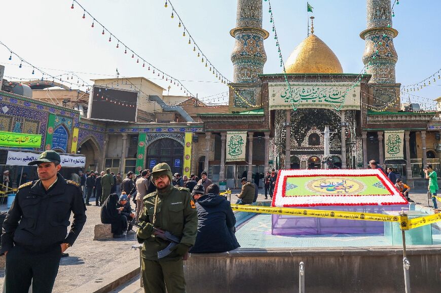 Policemen guard a Tehran polling station -- a low turnout was expected