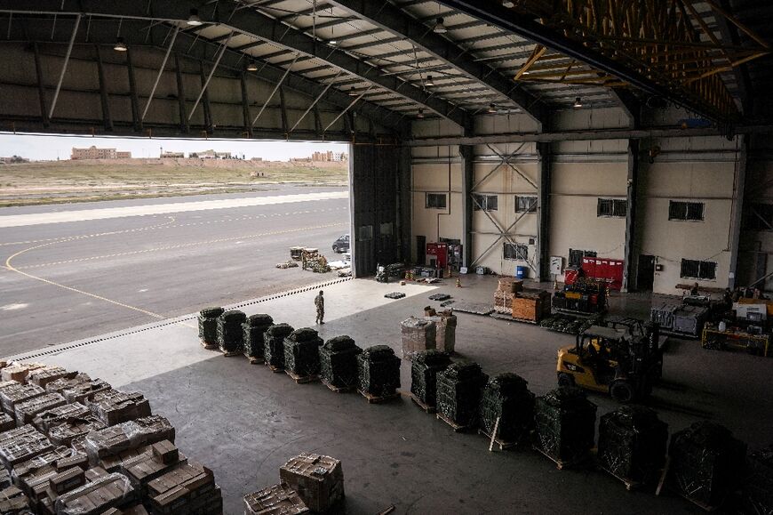 Humanitarian aid parcels are stacked up inside a warehouse at an airbase in Jordan, before being airdropped over the Gaza Strip