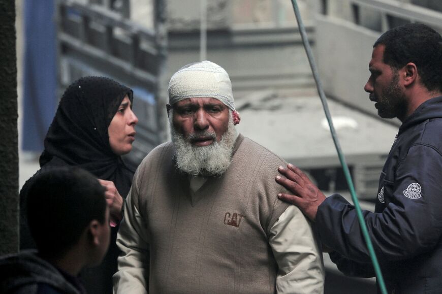 Palestinians inpect the rubble of a building in Deir al-Balah following Israeli bombardment on the central Gaza Strip