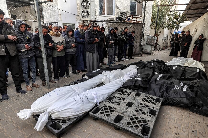 People perform funerary prayers for victims killed during Israeli bombardment the previous night, at al-Najar Hospital in Rafah in southern Gaza