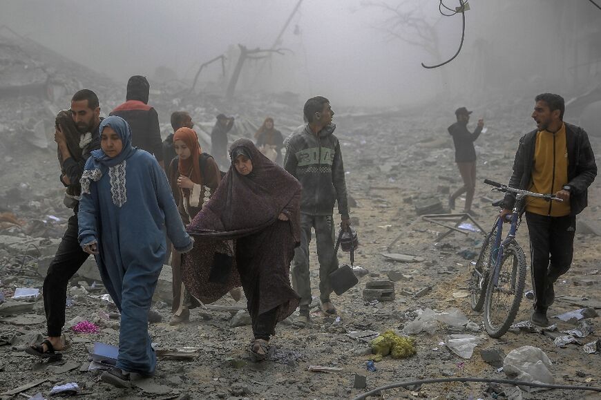 Palestinians flee after Israeli bombardment in central Gaza City on March 18, 2024 amid ongoing battles between Israel and the militant group Hamas