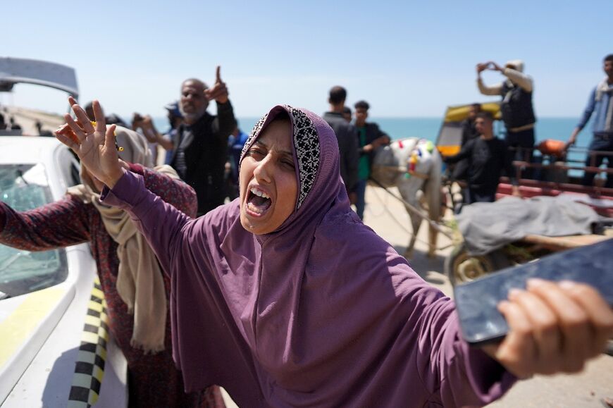 People react to seeing the bodies of relatives killed in Israeli bombardment at al-Zahra in the central Gaza Strip