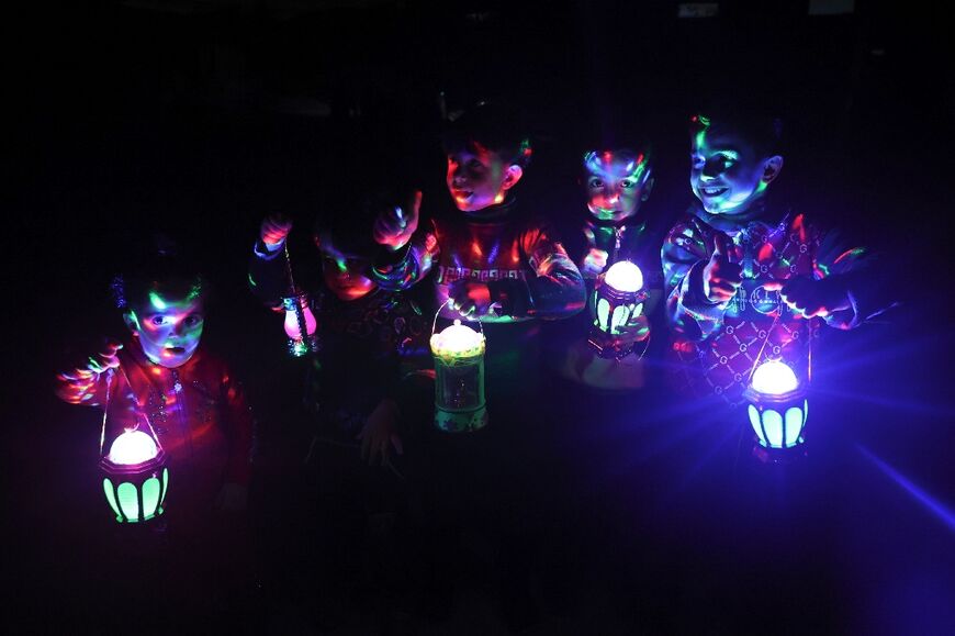 Palestinian children carry traditional "fanous" lanterns in Rafah, where Israel has vowed to send in troops