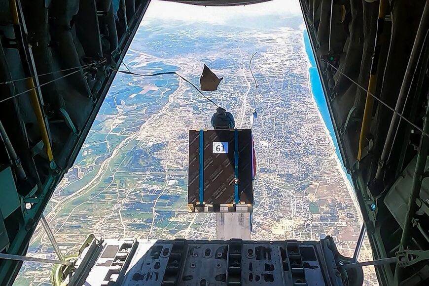 A picture released by the Jordanian Army shows humanitarian aid being dropped from a military aircraft over northern Gaza