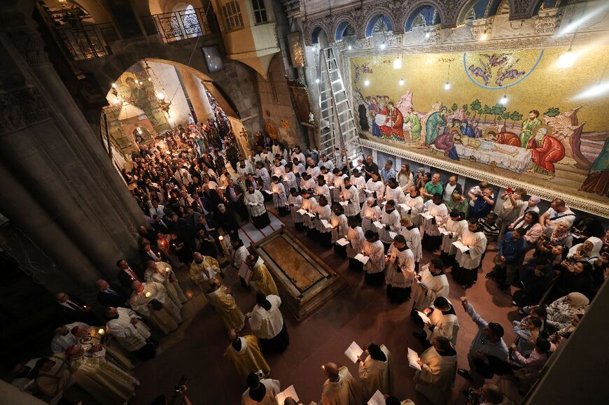 Christian worshippers and clergy gather in Jerusalem's church of the Holy Sepulchre built on what is said to be the tomb of Jesus to celebrate Easter with fewer people that usual because of the Israel-Hamas war raging in Gaza