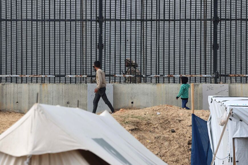 Displaced Gazans in the Rafah camps can see Egyptian soldiers on patrol just across the border fence