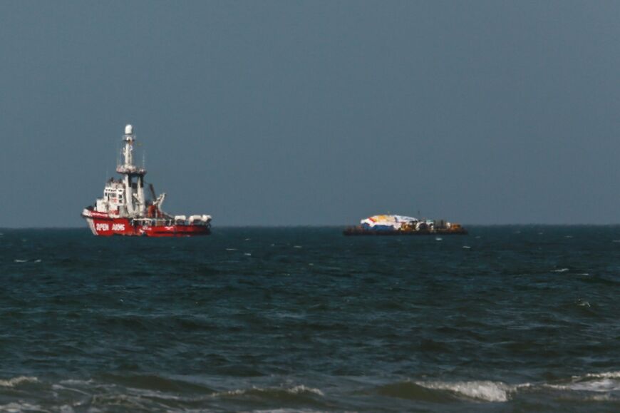 A charity vessel and a barge that sailed from Cyprus carrying humanitarian aid was off the shore of Gaza, awaiting approval to dock