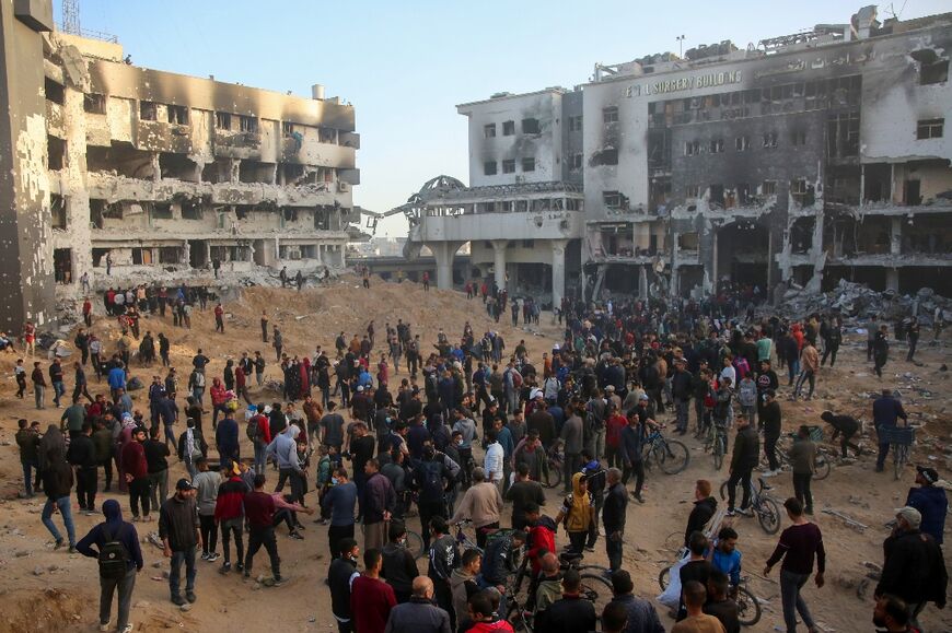 Palestinians inspect the damage at Gaza's Al-Shifa hospital after the Israeli military withdrew from the complex on April 1, 2024