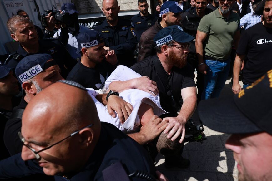 Israeli police detain a man at the site of a reported ramming attack in Jerusalem