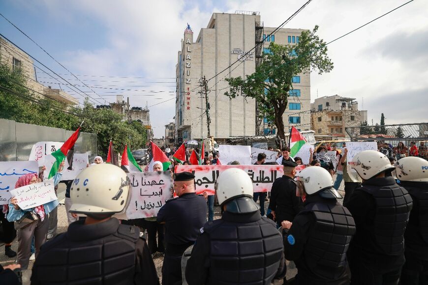 Palestinian Authority police prevent demonstrators from reaching the Canadian Representative Office in the occupied West Bank