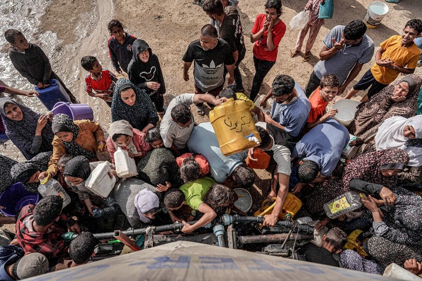 Palestinians collect water in Deir el-Balah in central Gaza, which has seen severe shortages during the war