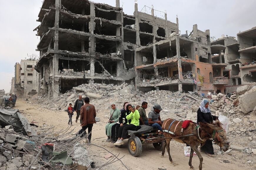 A Palestinian family return to the ruins of Khan Yunis, Gaza