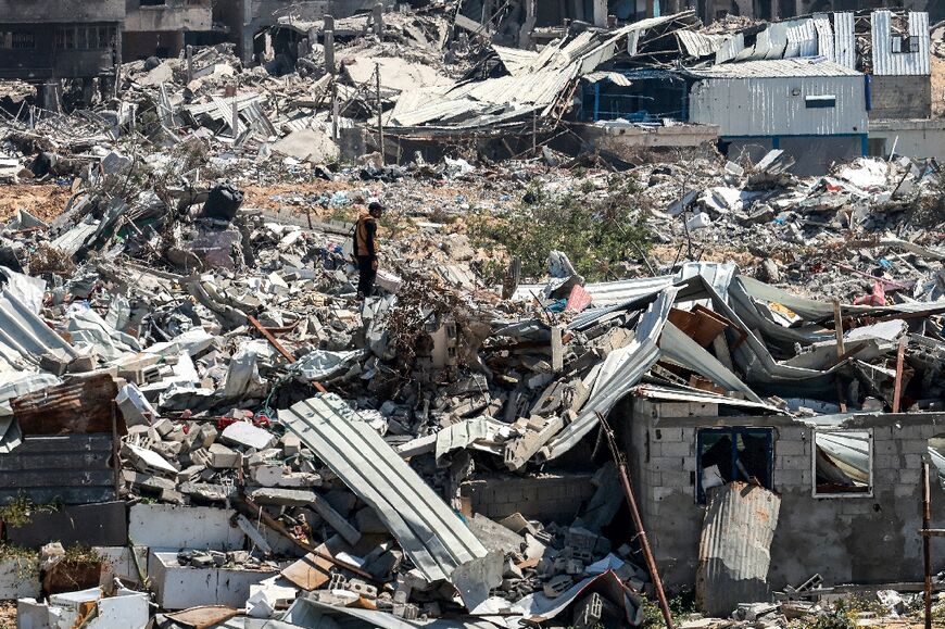 A man stands in the midst of the devastation of Khan Yunis, from which the Israeli army withdrew Sunday